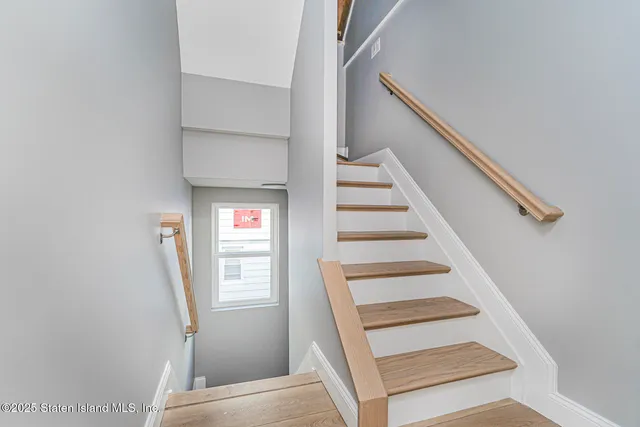 a view of staircase with white walls and a window