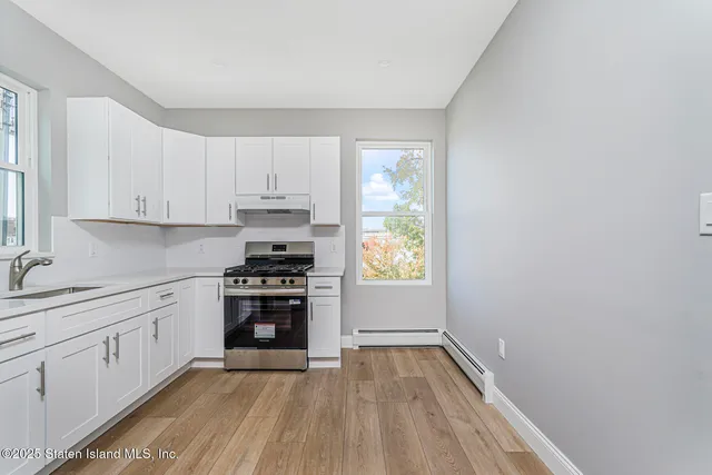 a kitchen with a sink stove and cabinets