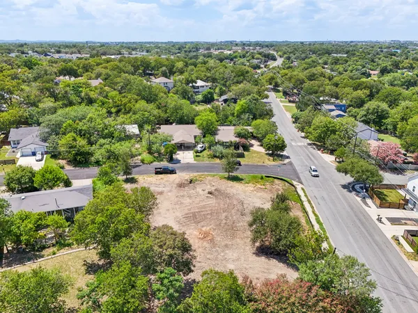 an aerial view of residential houses with outdoor space and street view