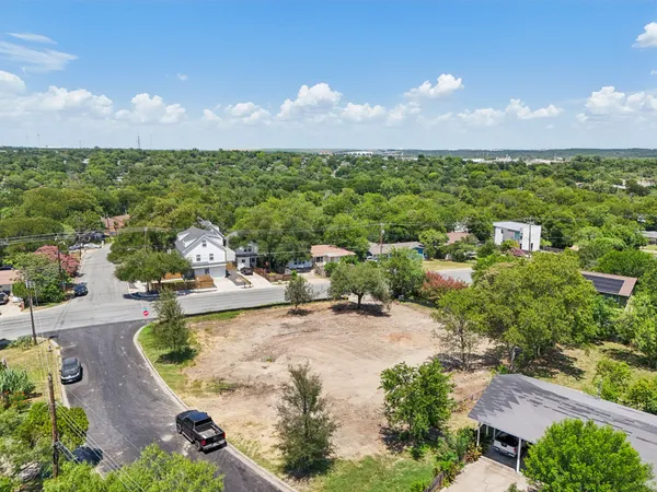 an aerial view of a house with a yard and lake view