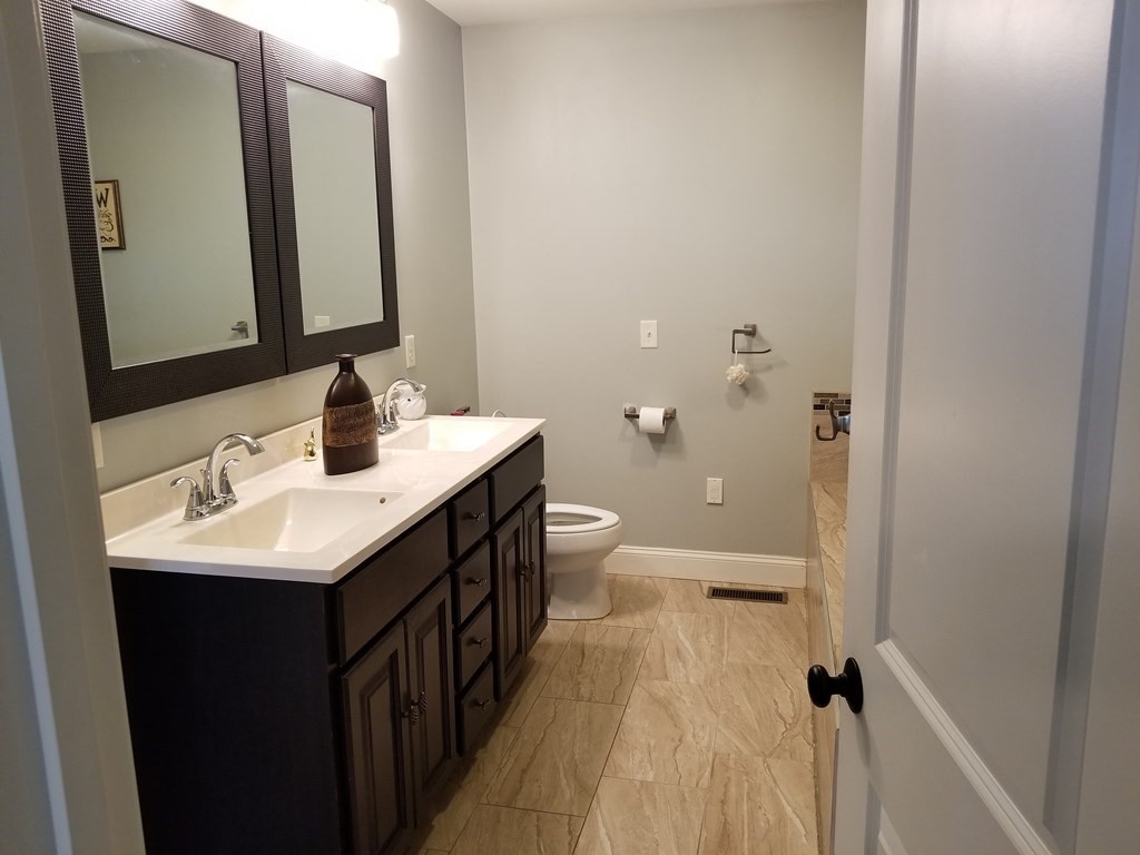 428 Smith Fall River Fall River, MA 02721 - Photo 20 of 31 a bathroom with a sink a toilet a mirror and shower