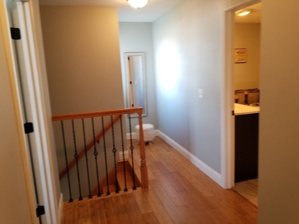 428 Smith Fall River Fall River, MA 02721 - Photo 23 of 31 a view of a hallway with wooden floor and staircase