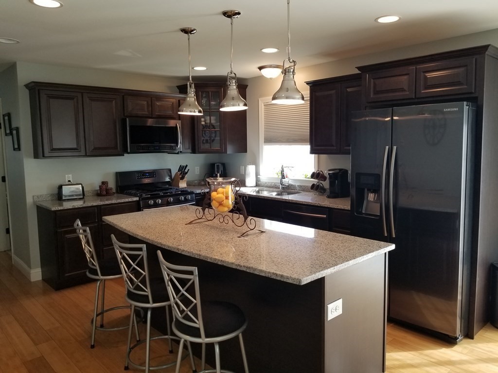 428 Smith Fall River Fall River, MA 02721 - Photo 3 of 31 a kitchen with a center island and refrigerator
