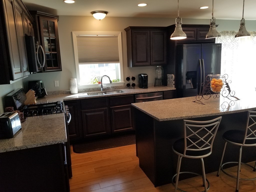 428 Smith Fall River Fall River, MA 02721 - Photo 4 of 31 a kitchen with granite countertop a sink appliances and cabinets