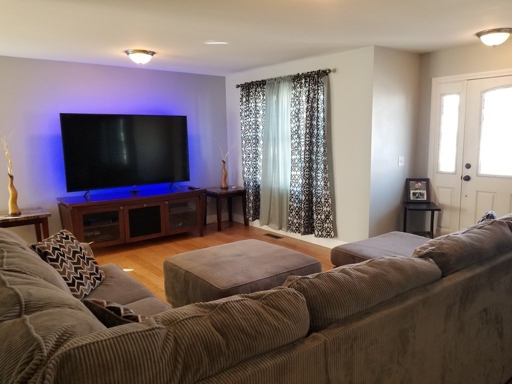 428 Smith Fall River Fall River, MA 02721 - Photo 9 of 31 a living room with furniture and a flat screen tv