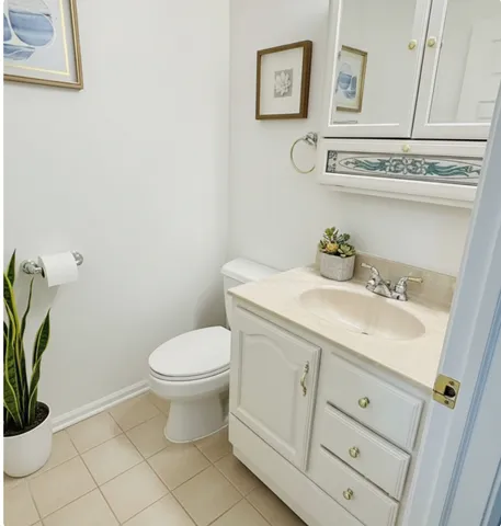 a bathroom with a sink a toilet and vanity