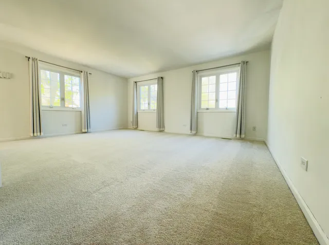a view of an empty room with windows