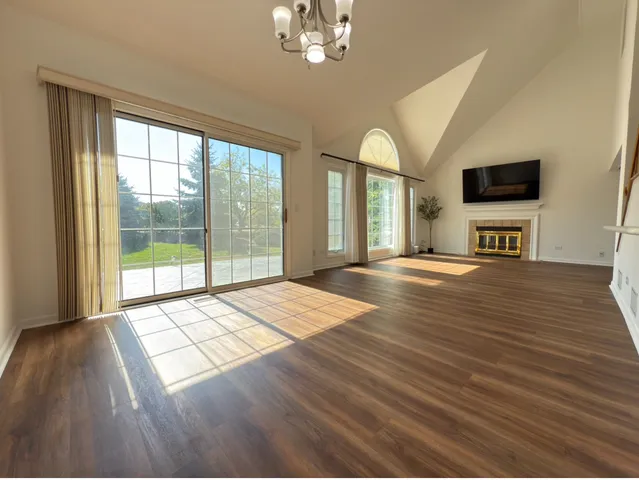 a view of a livingroom with furniture wooden floor and chandelier