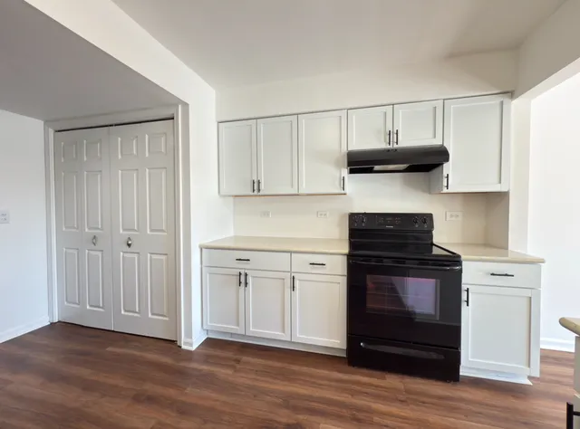 a kitchen with stainless steel appliances granite countertop a stove and a cabinets