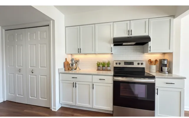 a kitchen with stainless steel appliances granite countertop a stove and a microwave