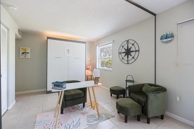 a living room with furniture a clock and a window