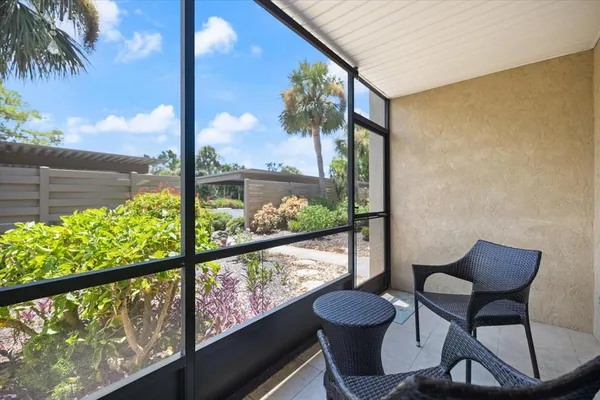 a view of a chair and table in the balcony