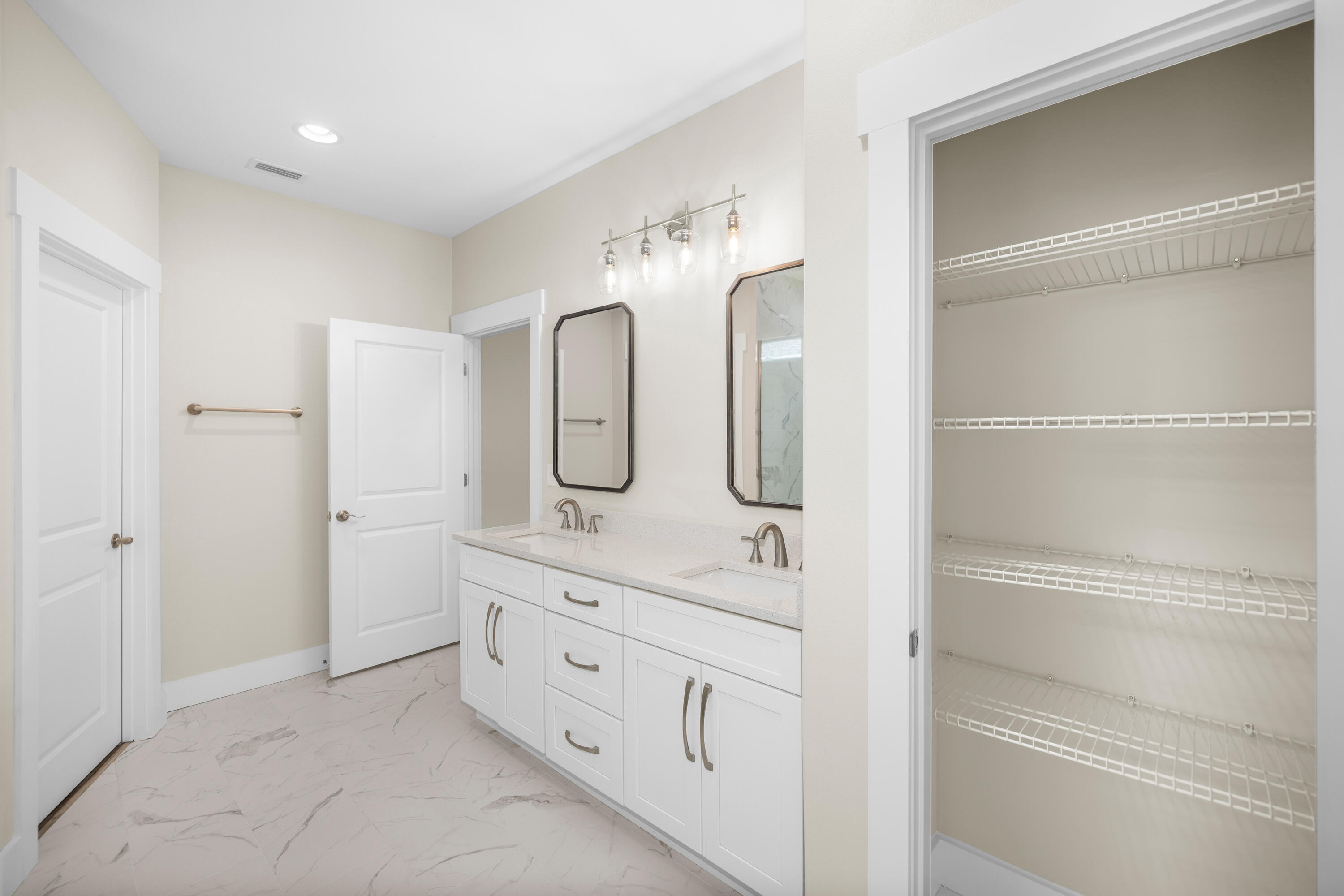 61 Spruce Street Freeport, FL 32439 - Photo 13 of 35 a bathroom with a double vanity sink a mirror and a shower