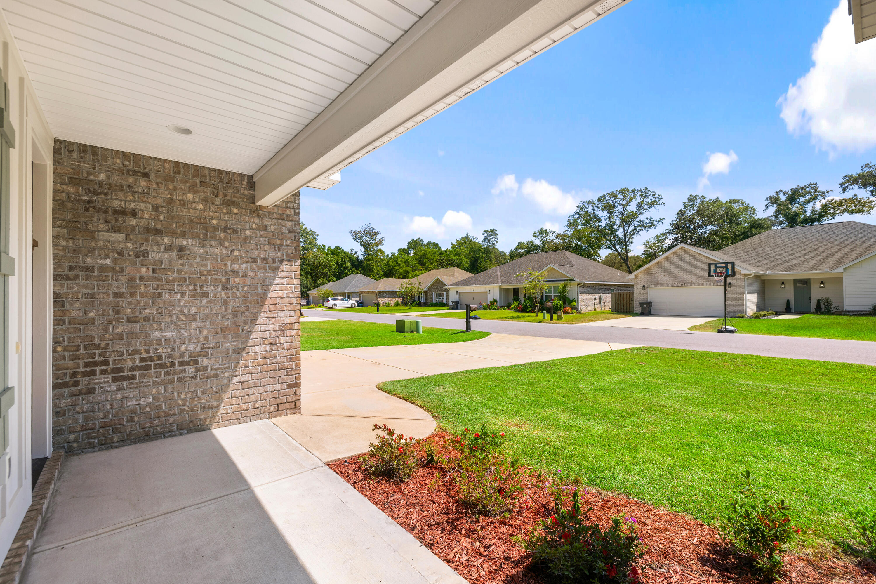 61 Spruce Street Freeport, FL 32439 - Photo 28 of 35 a front view of a house with garden