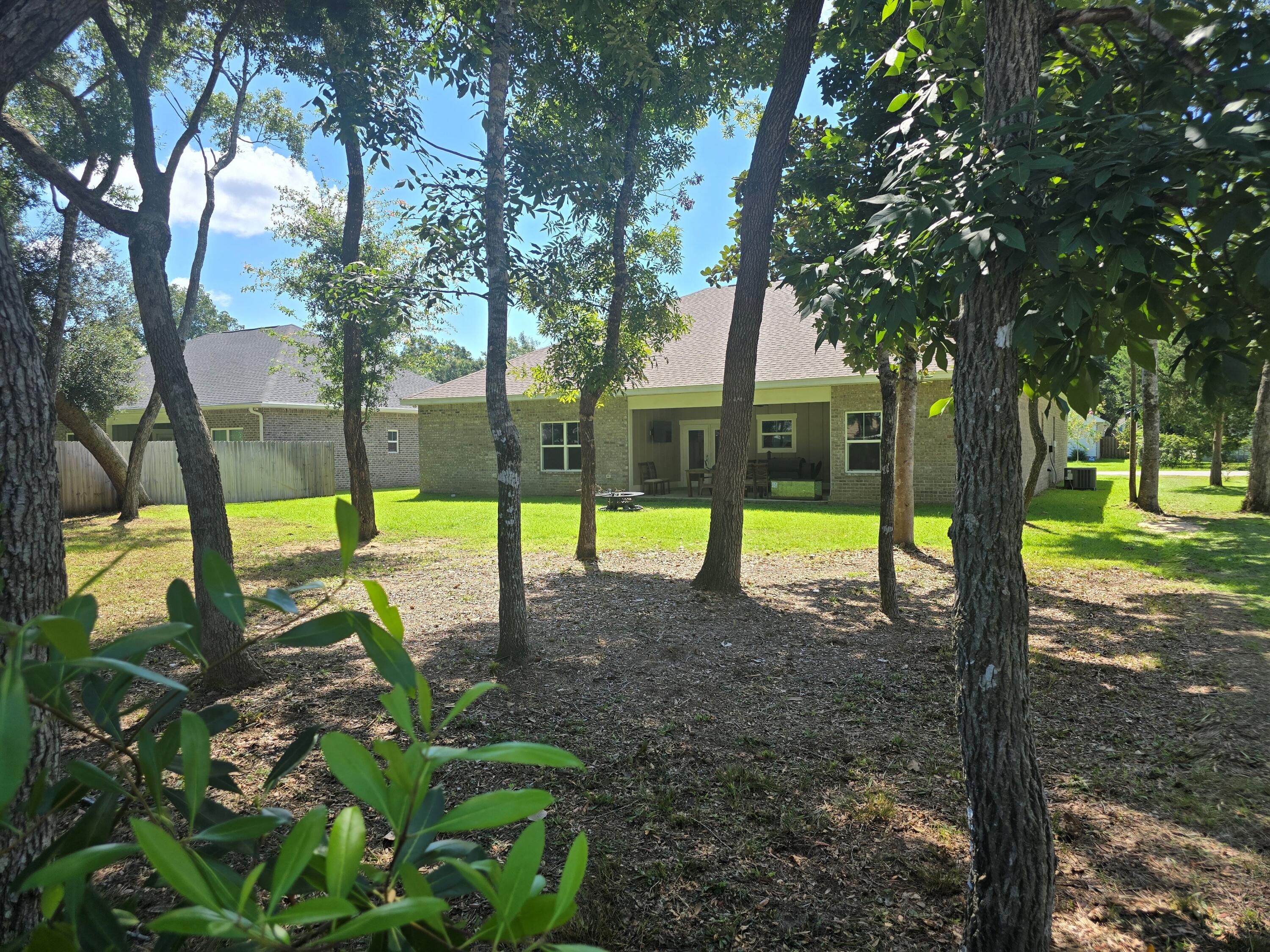 61 Spruce Street Freeport, FL 32439 - Photo 29 of 35 a view of a house with a backyard