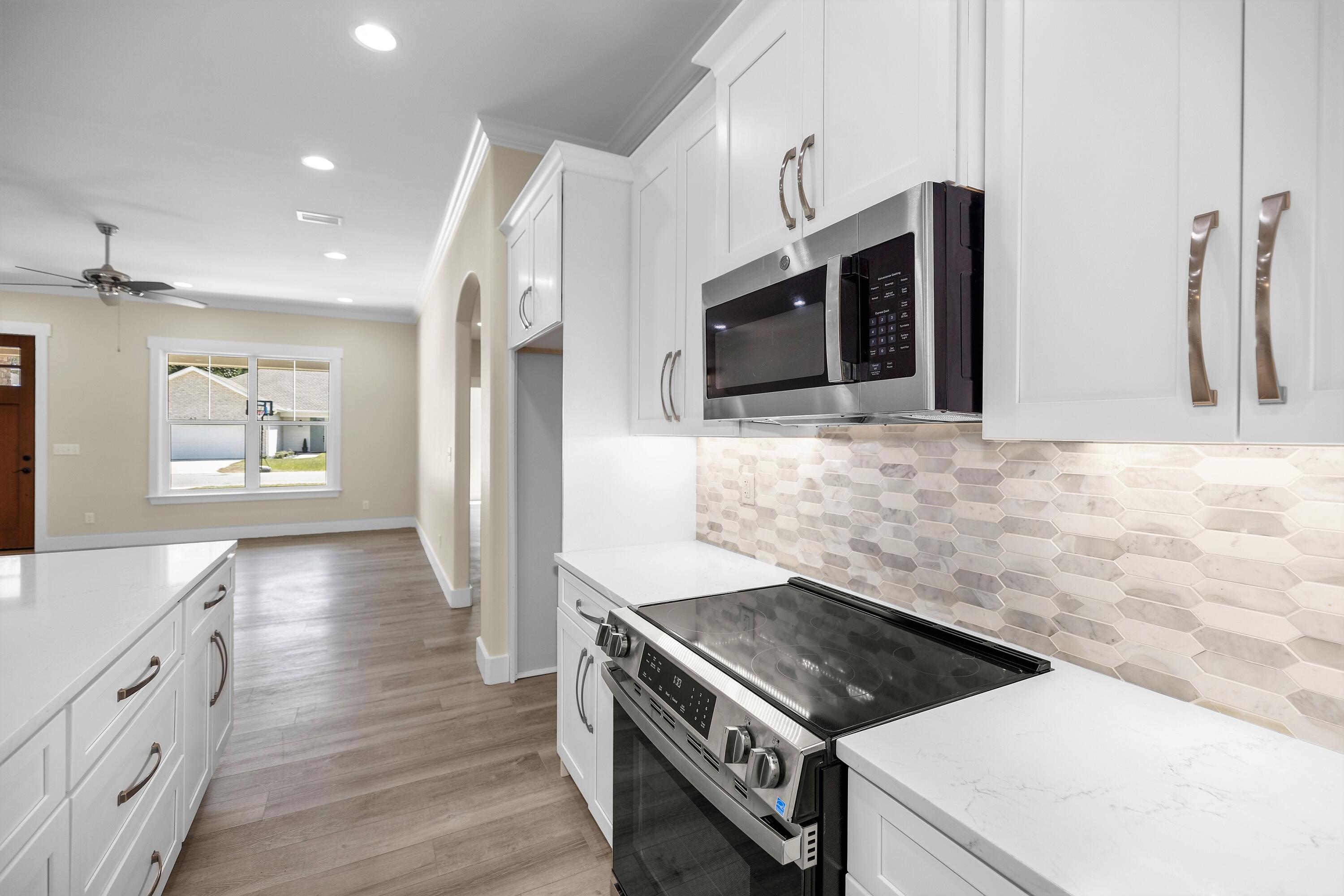 61 Spruce Street Freeport, FL 32439 - Photo 7 of 35 a kitchen that has a stove and a microwave