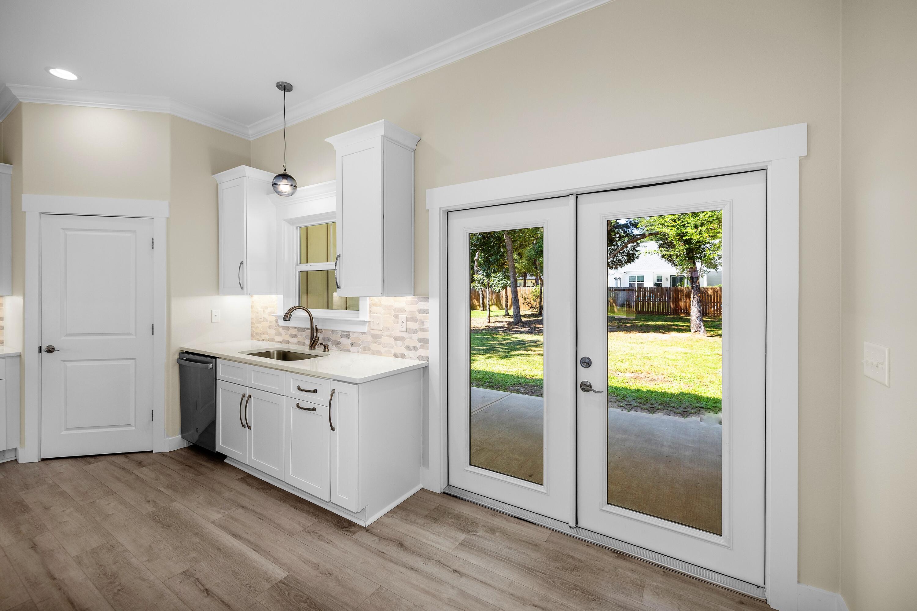61 Spruce Street Freeport, FL 32439 - Photo 9 of 35 a bathroom with a double vanity sink and a mirror