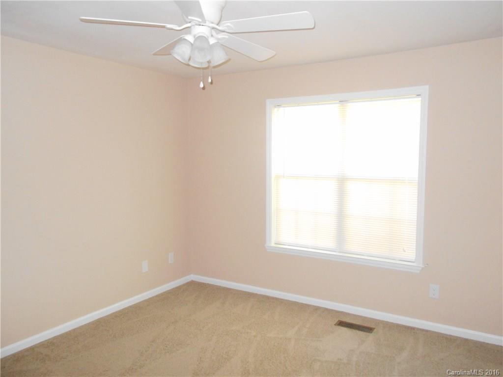 6733 Bevington Ridge Road, Unit A & B Charlotte, NC 28277 - Photo 12 of 18 an empty room with a window and a fan