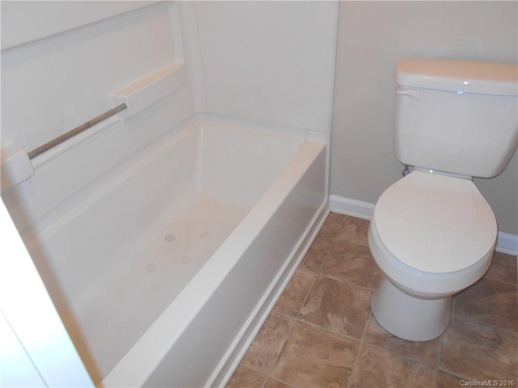 6733 Bevington Ridge Road, Unit A & B Charlotte, NC 28277 - Photo 14 of 18 a bathroom with a toilet and a bathtub
