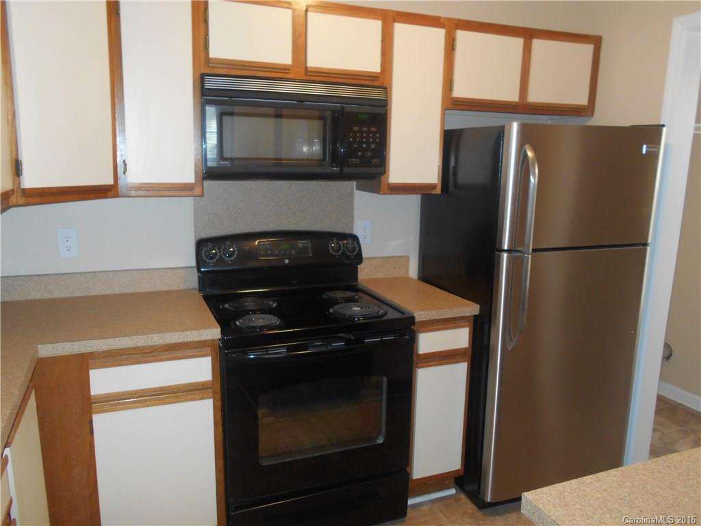 6733 Bevington Ridge Road, Unit A & B Charlotte, NC 28277 - Photo 5 of 18 a kitchen with a refrigerator stove and microwave