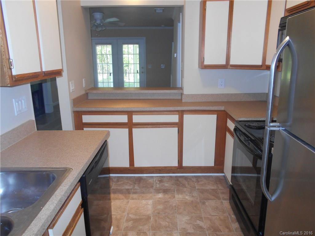 6733 Bevington Ridge Road, Unit A & B Charlotte, NC 28277 - Photo 7 of 18 a kitchen with a refrigerator and a sink