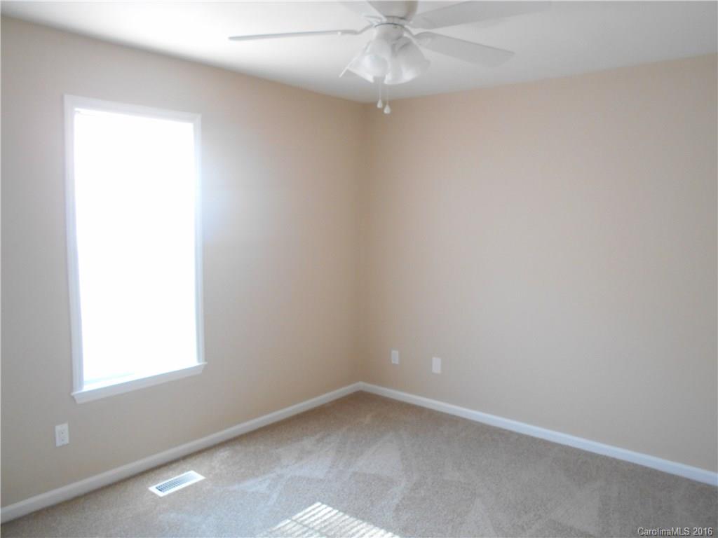 6733 Bevington Ridge Road, Unit A & B Charlotte, NC 28277 - Photo 8 of 18 an empty room with a window and a fan