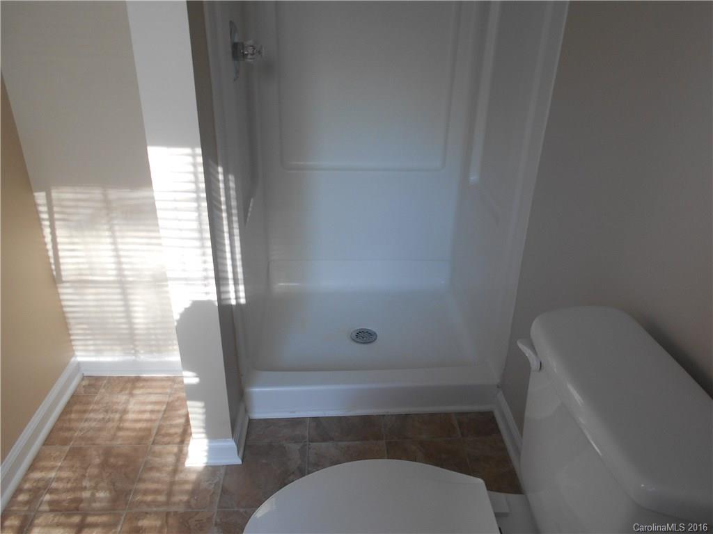 6733 Bevington Ridge Road, Unit A & B Charlotte, NC 28277 - Photo 10 of 18 a bathroom with a toilet and a shower