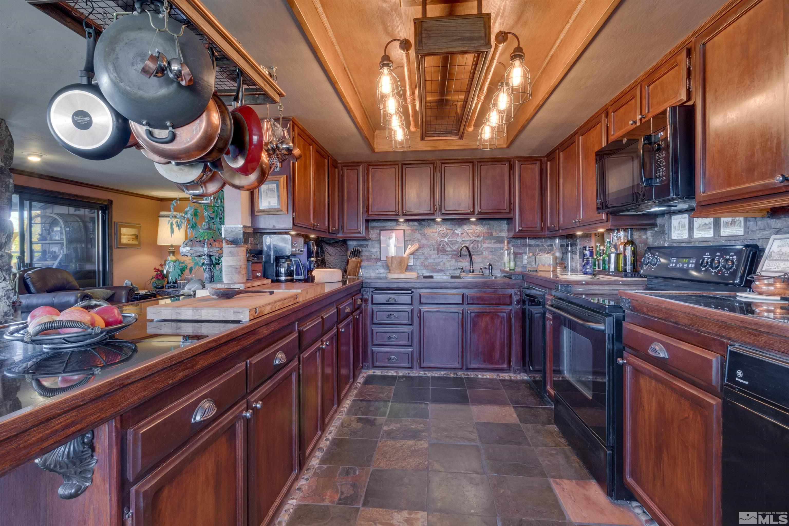 2087 Chanslor Circle Reno, NV 89509 - Photo 14 of 29 a kitchen with a large island in the center and stainless steel appliances