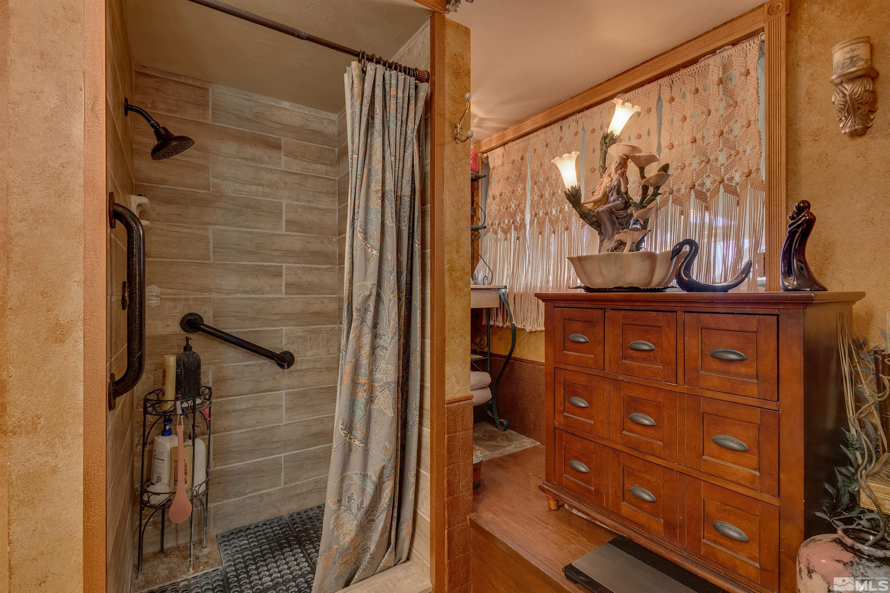 2087 Chanslor Circle Reno, NV 89509 - Photo 22 of 29 a bathroom with a granite countertop sink a mirror and shower
