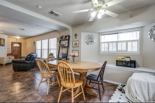 a dining room with furniture and window