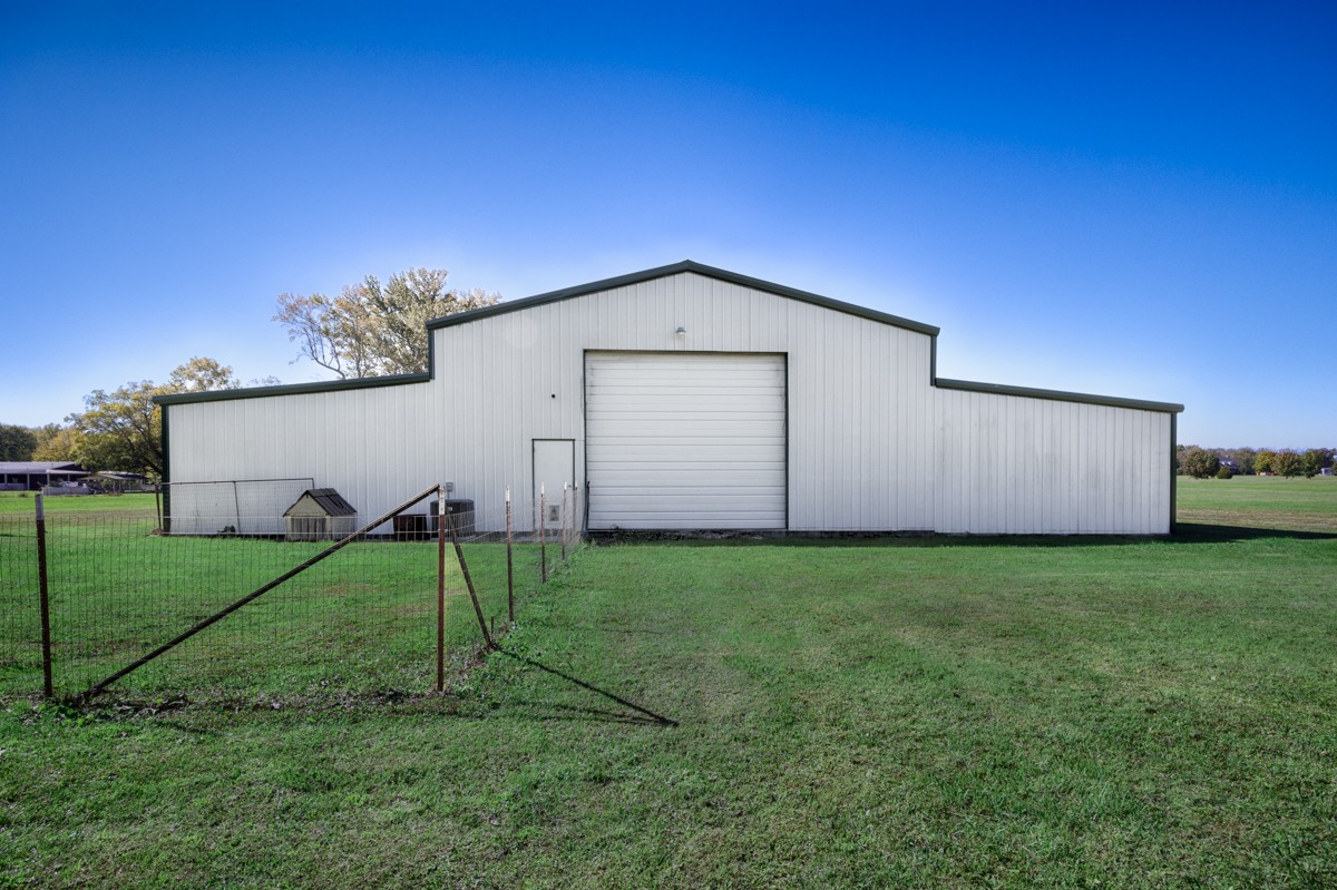 167 Henry Bayless Road Ardmore, TN 38449 - Photo 22 of 30 a backyard of a house with a table and a chair