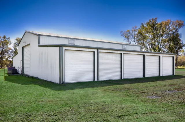 a view of a house with backyard and trees