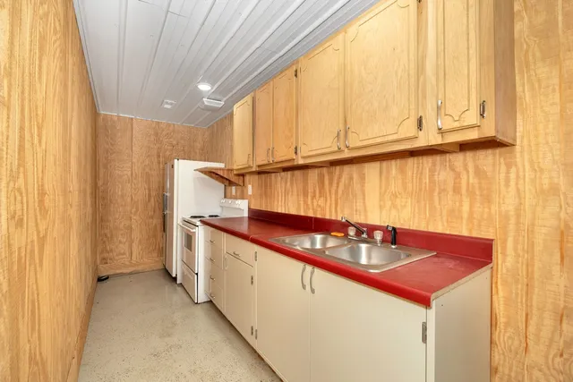a kitchen with stainless steel appliances granite countertop a sink a stove and a microwave