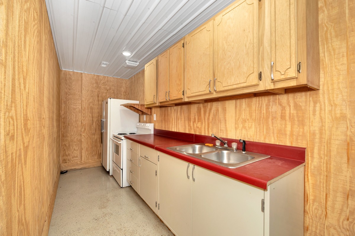 167 Henry Bayless Road Ardmore, TN 38449 - Photo 4 of 30 a kitchen with stainless steel appliances granite countertop a sink a stove and a microwave
