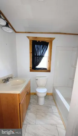 a bathroom with a sink a toilet and a bathtub