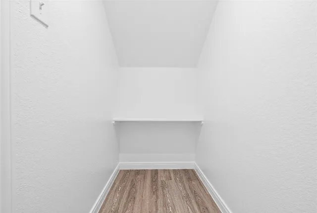 a view of room with wooden floor