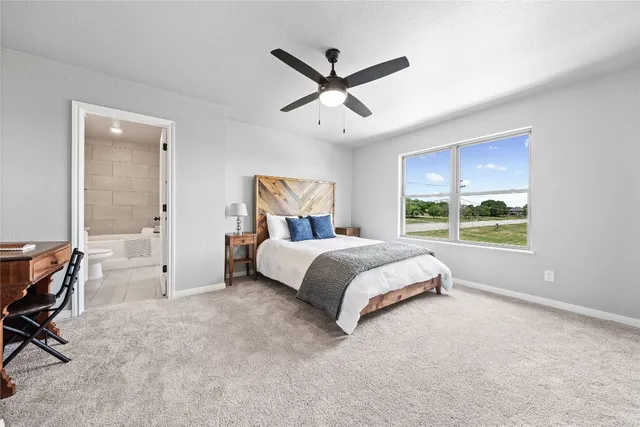 a bedroom with a bed and large window