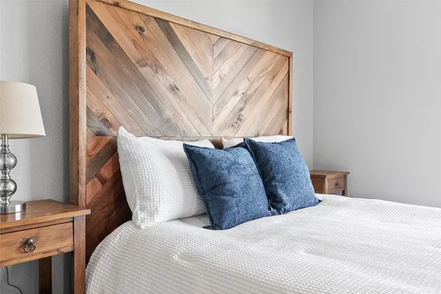 a large bed sitting in a bedroom next to a window