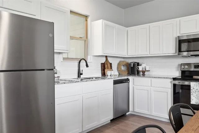 a kitchen with a sink appliances and cabinets