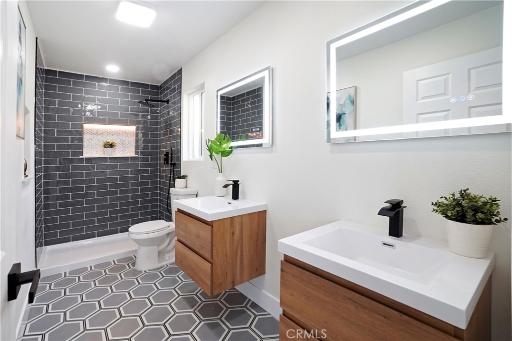 5571 Central Avenue Riverside, CA 92504 - Photo 6 of 21 a bathroom with a sink a toilet and mirror