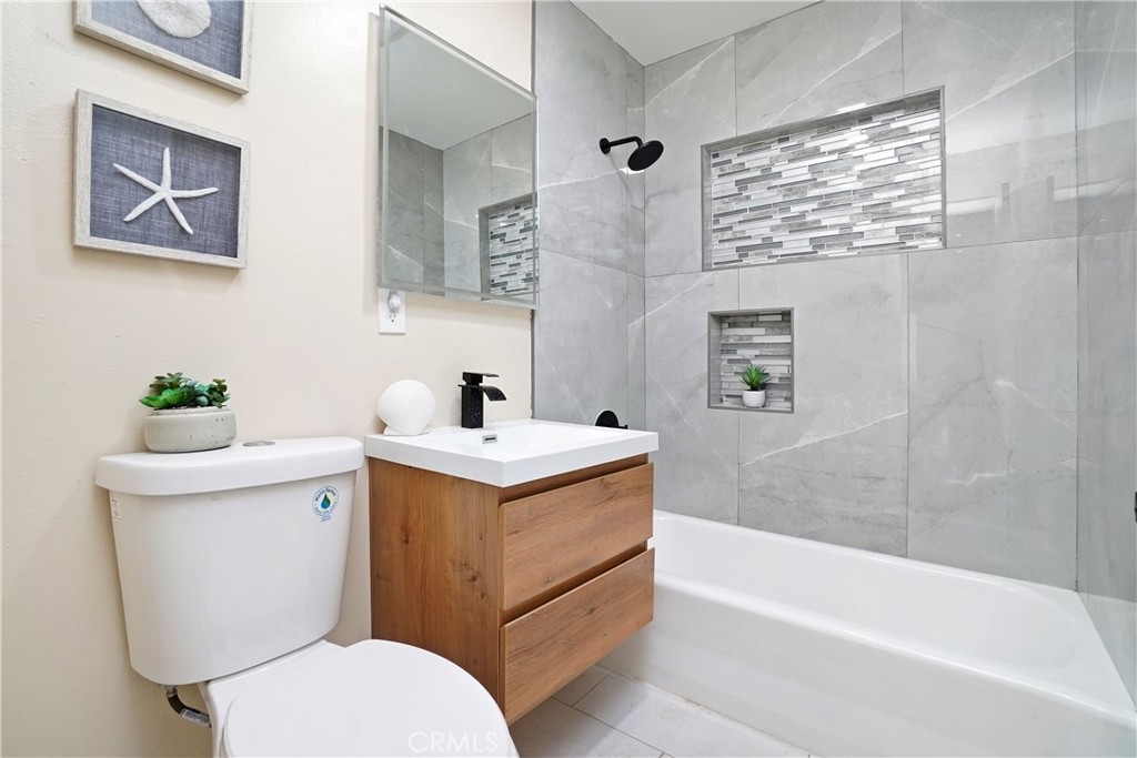 5571 Central Avenue Riverside, CA 92504 - Photo 9 of 21 a bathroom with a sink mirror vanity and toilet