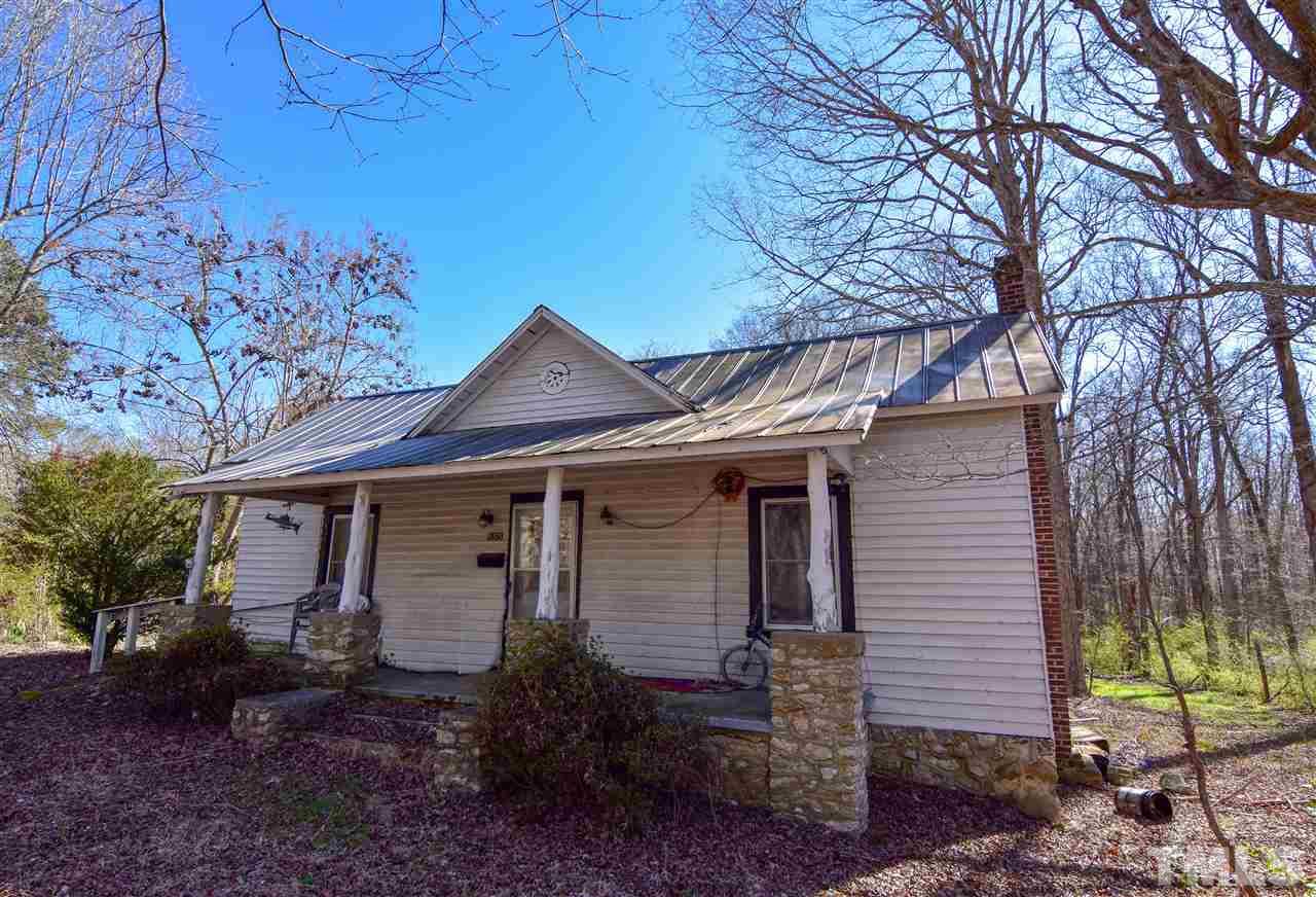 5175 Hurdle Mills Road Roxboro, NC 27574 - Photo 3 of 10 a front view of a house with a garden