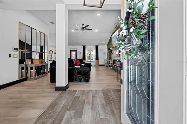 a view of a livingroom with wooden floor and a fireplace