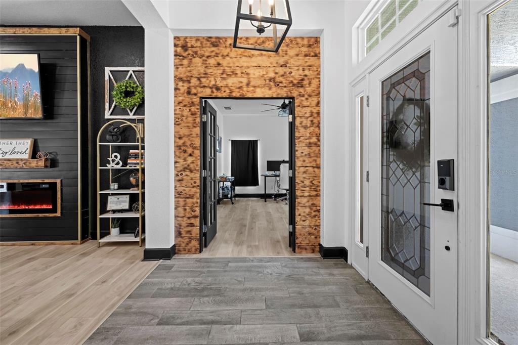 12034 Mandlin Road Weeki Wachee, FL 34614 - Photo 14 of 51 a view of a livingroom with wooden floor and a fireplace