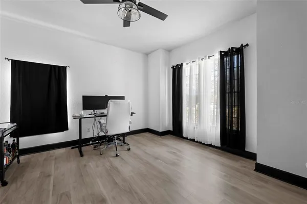 a hallway with wooden floor and furniture