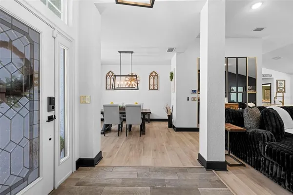 a dining room with furniture and a window
