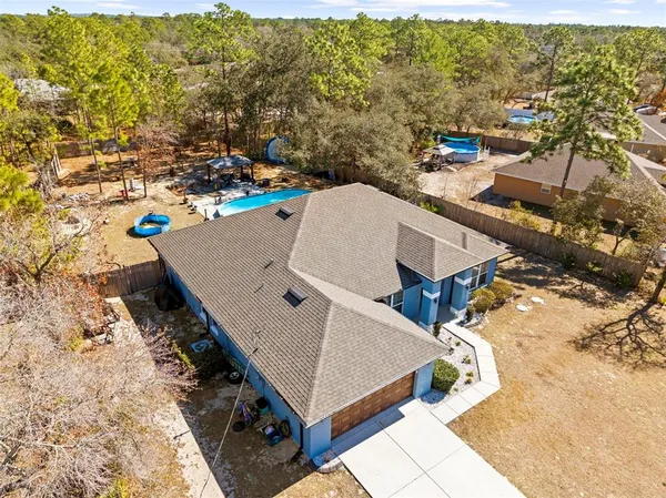 an aerial view of a house with a yard