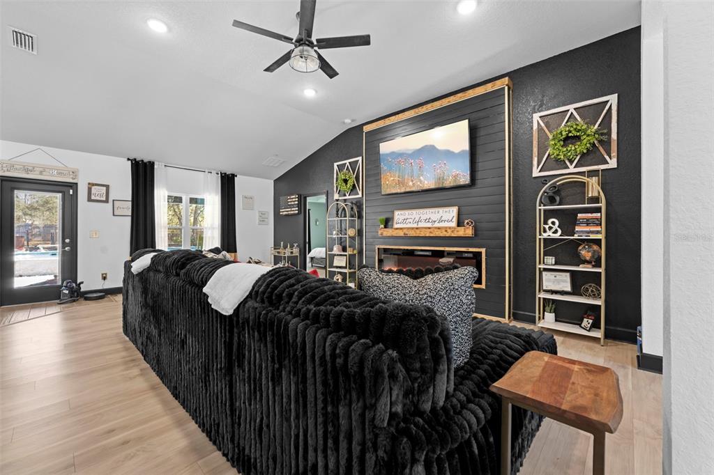 12034 Mandlin Road Weeki Wachee, FL 34614 - Photo 22 of 51 a bed room with furniture and a flat screen tv