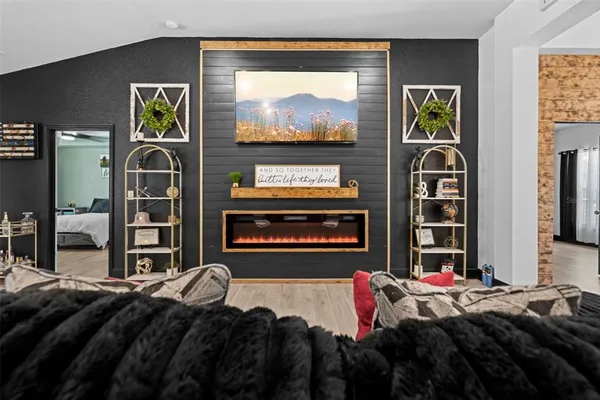 a living room with furniture fireplace and flat screen tv
