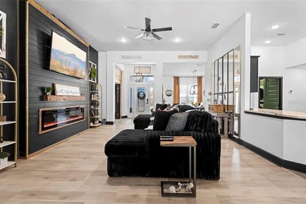 a living room with furniture and kitchen view